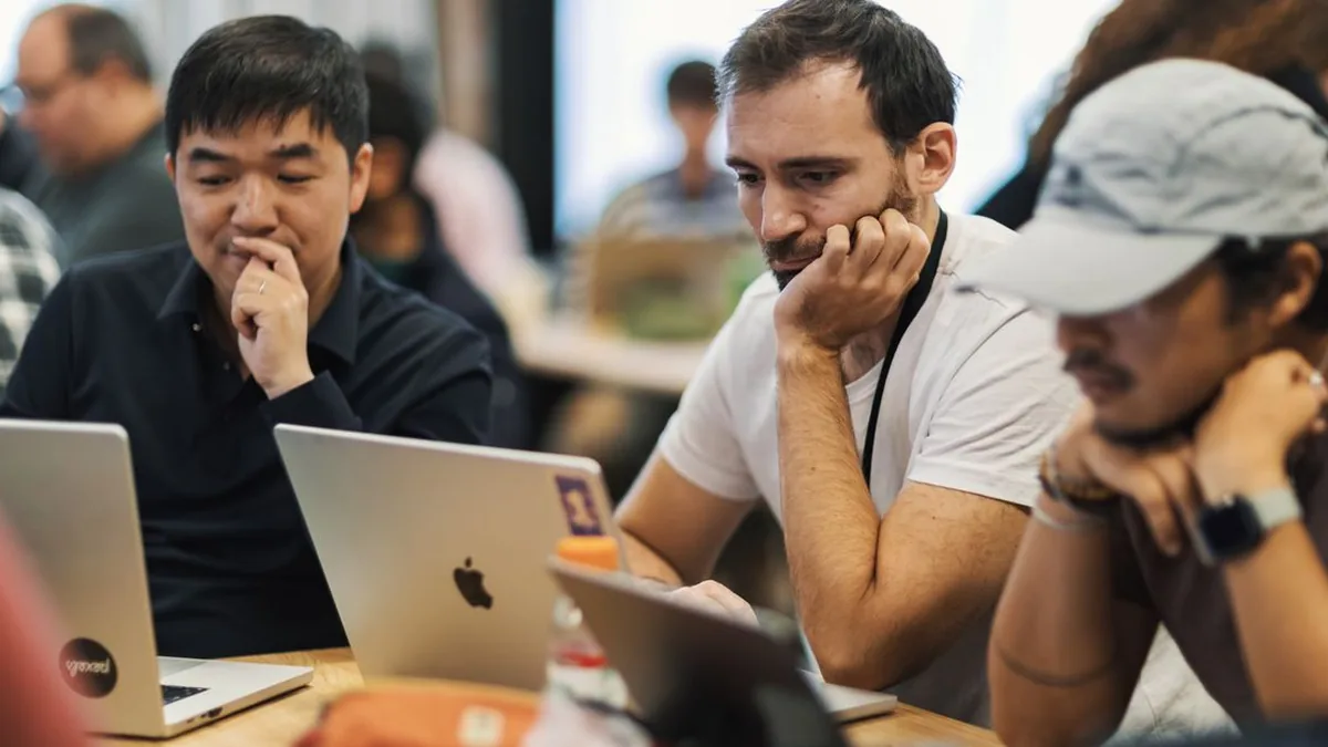 A technical team assigning weighted scores to software tools on a shared evaluation board (Photo by Matheus Bertelli, Pexels)