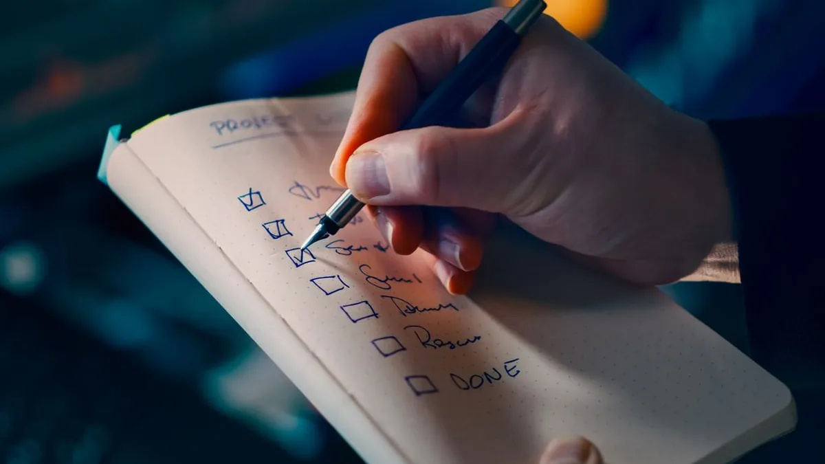 Two marketers reviewing queued outreach drafts together on a laptop before approving them (Photo by Jakub Zerdzicki, Pexels)