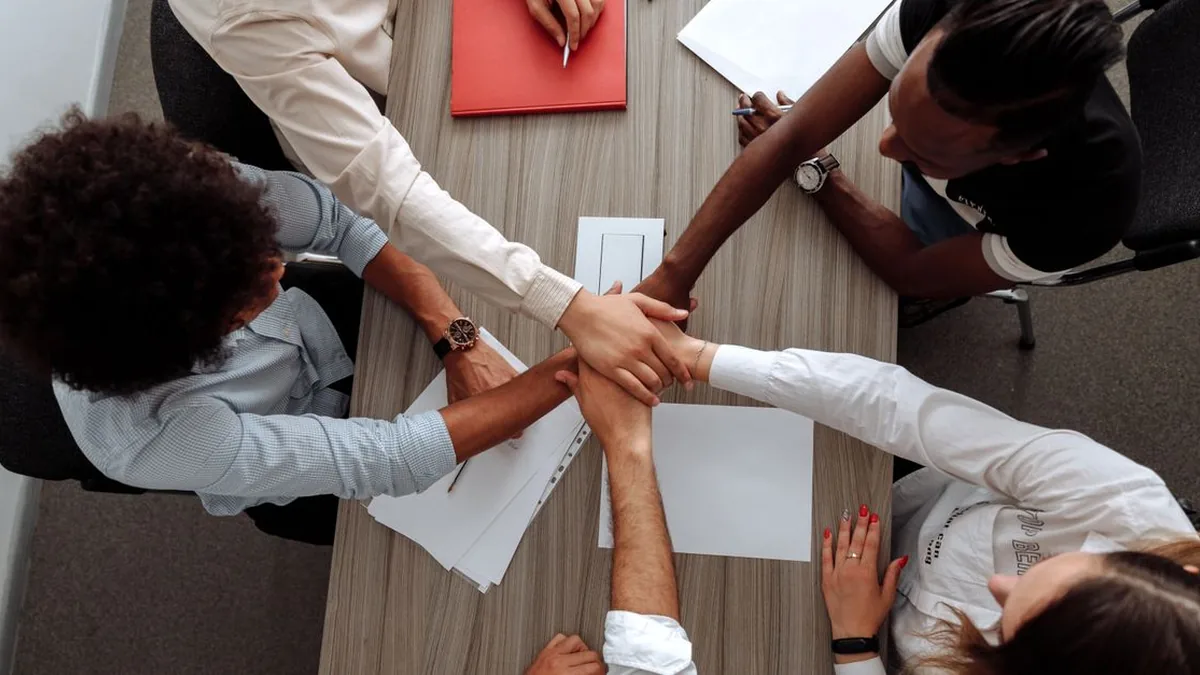 A growing customer service team collaborating around a shared support queue (Photo by Thirdman, Pexels)