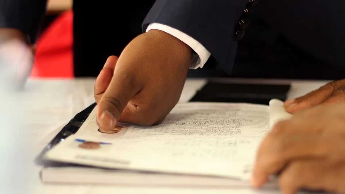 A small team reviewing a request and approval checklist together at a table (Photo by Kefuoe Josenta, Pexels)