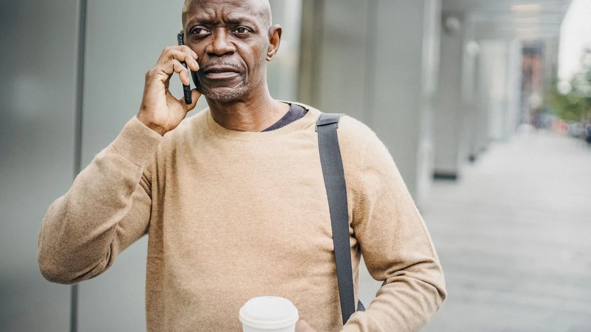 A church staff member having a warm phone conversation with a short call guide and notes nearby (Photo by Ono  Kosuki, Pexels)