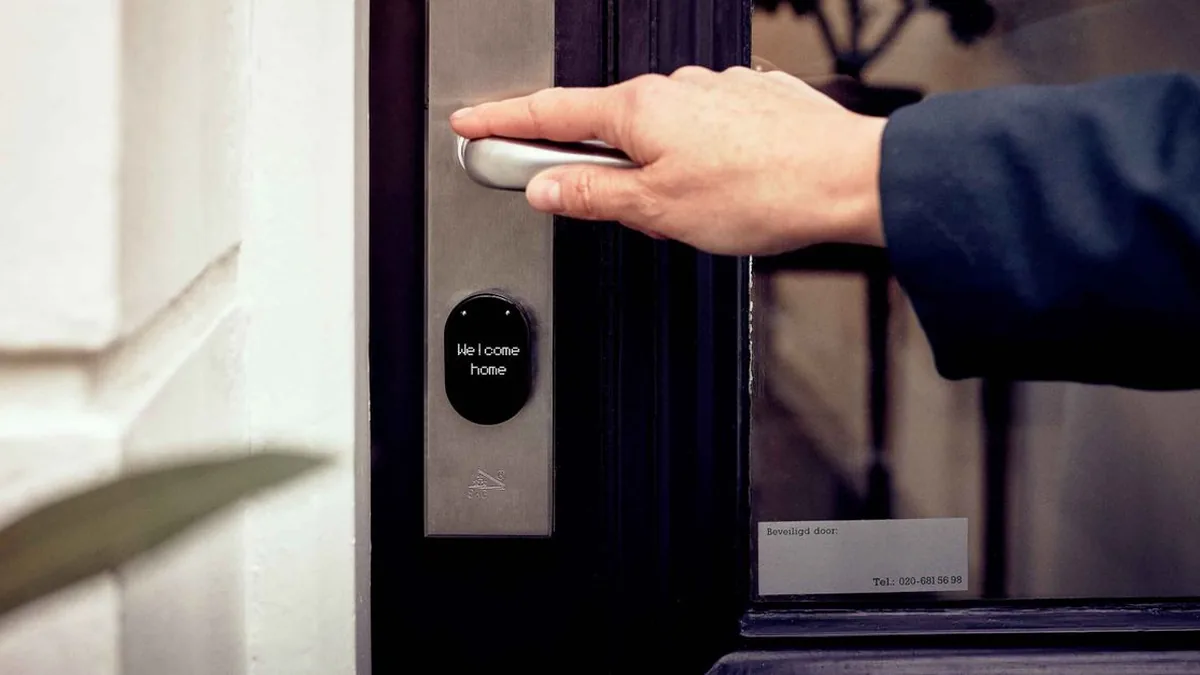 A renter using a temporary smart-lock or lockbox code to enter an apartment for a self-guided tour (Photo by Joppe Beurskens, Pexels)