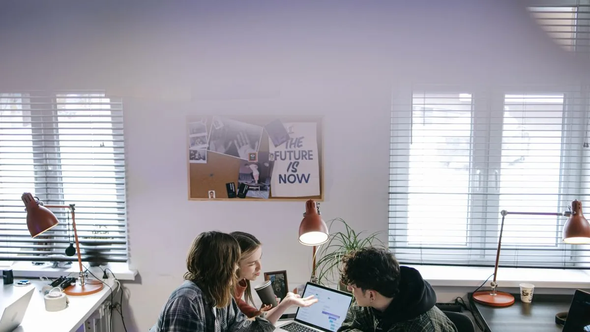 A workplace team collaborates around documents and a Microsoft Teams meeting (Photo by Ivan S, Pexels)