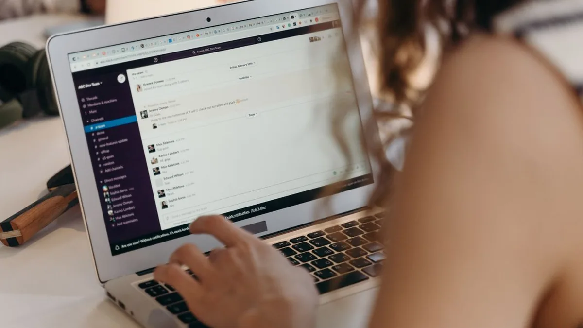 A marketer examining engagement patterns by day and time before scheduling an email campaign (Photo by cottonbro studio, Pexels)