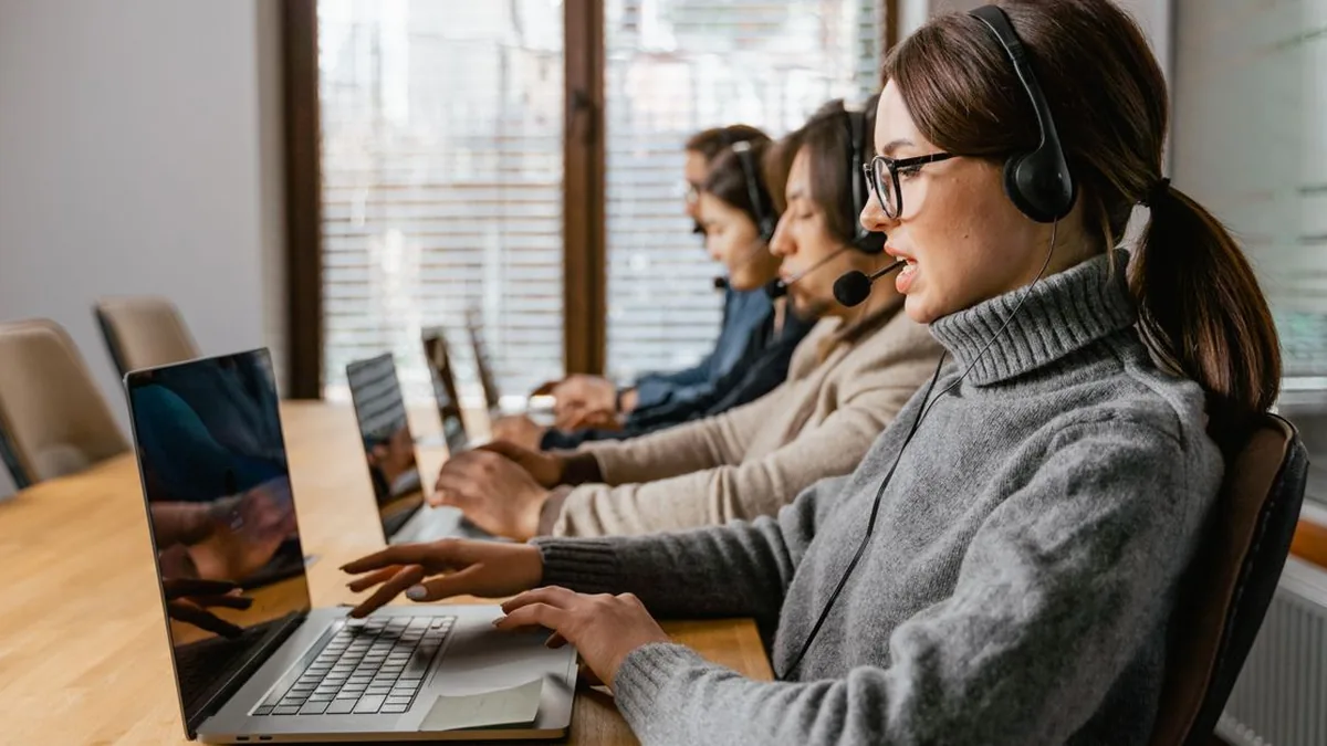 A real estate agent reviewing clearly separated contact stages on a laptop at a desk (Photo by MART PRODUCTION, Pexels)