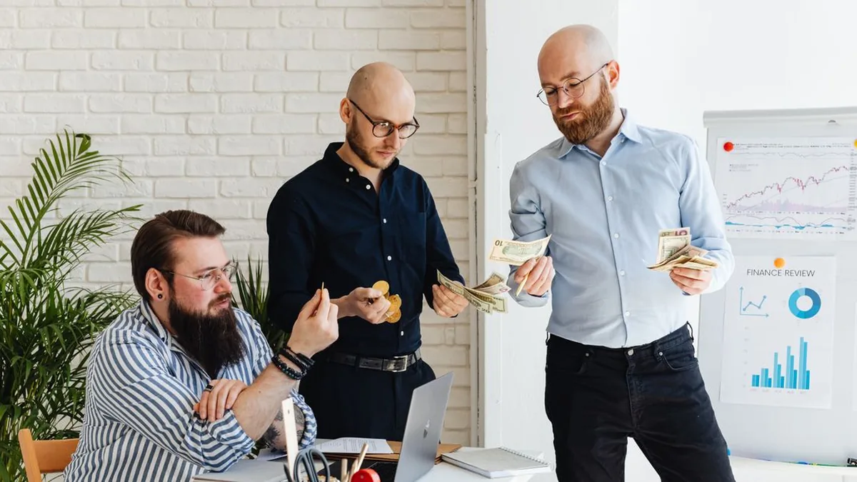 A small marketing team comparing campaign costs and monthly email volume on a shared screen (Photo by www.kaboompics.com, Pexels)