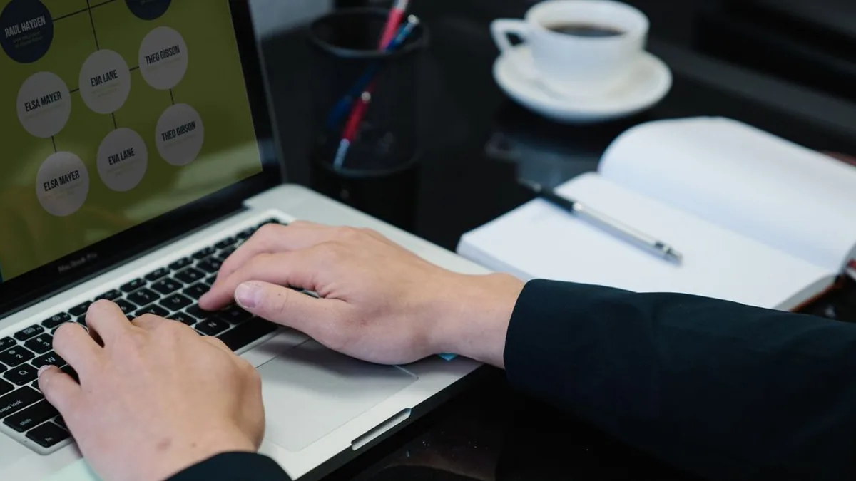 A church administrator recording visitor outcomes and follow-up tasks at a laptop (Photo by Felicity Tai, Pexels)