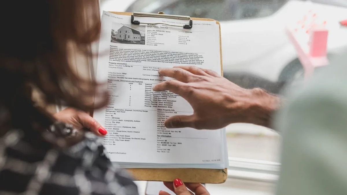 A consultant checking signed agreements, intake forms, identity details, and client documents (Photo by RDNE Stock project, Pexels)