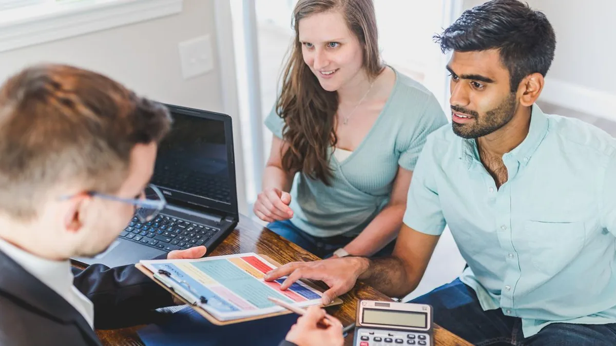A loan officer and Realtor discussing a homebuyer referral at a meeting table (Photo by RDNE Stock project, Pexels)