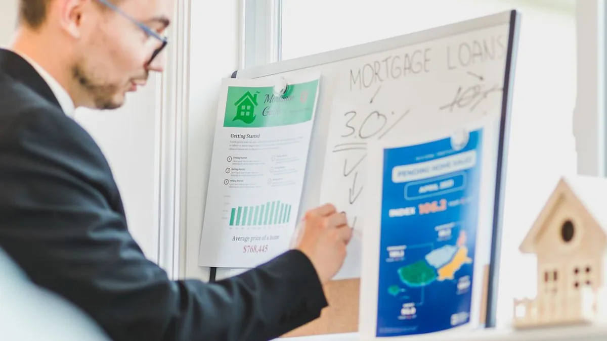 A loan officer viewing a CRM-style mortgage pipeline dashboard on a desktop monitor (Photo by RDNE Stock project, Pexels)