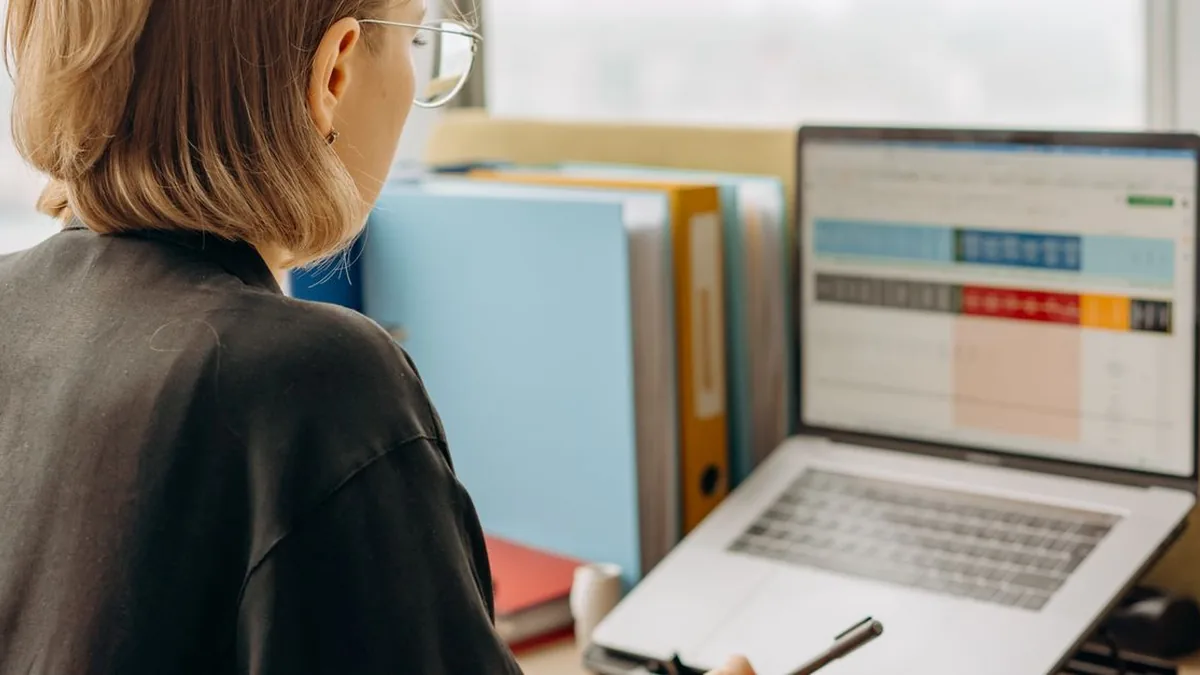 An administrator configuring customer records and account settings on a laptop.