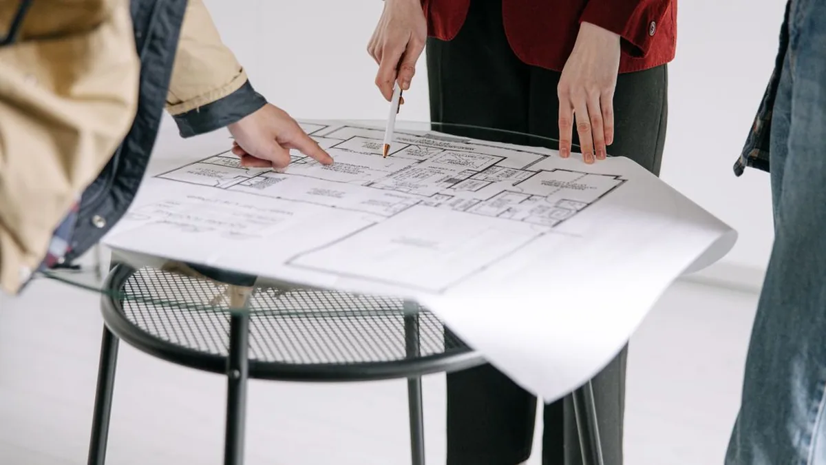 A project team organizing client milestones, responsibilities, documents, and delivery dates (Photo by Ivan S, Pexels)